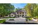 Stunning two-story home featuring a brick facade, lush landscaping, and a spacious driveway at 450 Birkdale Dr, Fayetteville, GA 30215