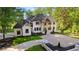 A brick two-story home features manicured lawn, beautiful window shutters, and a spacious driveway at 450 Birkdale Dr, Fayetteville, GA 30215