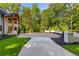 Exterior features beautiful stone facade, manicured lawn, and a spacious driveway at 450 Birkdale Dr, Fayetteville, GA 30215