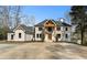 Elegant two-story home featuring a light brick facade, a symmetrical design, and a spacious front yard at 450 Birkdale Dr, Fayetteville, GA 30215