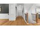 Welcoming hallway with wood floors, white wainscoting, and staircase with iron balusters at 450 Birkdale Dr, Fayetteville, GA 30215