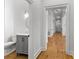 Hallway featuring hardwood floors and a glimpse of a half bathroom at 450 Birkdale Dr, Fayetteville, GA 30215
