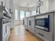Bright kitchen features a gray island with black hardware, stainless steel oven, and hardwood floors at 450 Birkdale Dr, Fayetteville, GA 30215