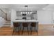 Modern kitchen island with seating, stainless steel appliances, and gray cabinetry at 450 Birkdale Dr, Fayetteville, GA 30215