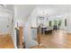 Second-story staircase landing with open view into updated kitchen featuring large island and pendant lighting at 450 Birkdale Dr, Fayetteville, GA 30215