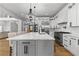 Gourmet kitchen boasts a large island, stainless appliances, and designer lighting at 450 Birkdale Dr, Fayetteville, GA 30215