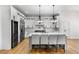 Modern kitchen with white cabinets, stainless steel appliances, and an island with bar seating at 450 Birkdale Dr, Fayetteville, GA 30215
