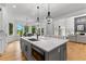 Open kitchen featuring a center island, quartz counters, and stainless appliances at 450 Birkdale Dr, Fayetteville, GA 30215