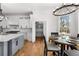 Modern kitchen with large island, white countertops, stainless steel appliances, and an adjacent breakfast nook at 450 Birkdale Dr, Fayetteville, GA 30215