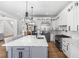 Spacious kitchen features a large island with quartz countertops, stainless steel appliances, and hardwood floors at 450 Birkdale Dr, Fayetteville, GA 30215