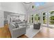 Open-concept living room with hardwood floors, high ceilings, and access to a balcony at 450 Birkdale Dr, Fayetteville, GA 30215