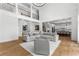 Open concept living room with hardwood floors, high ceilings and view of adjacent kitchen at 450 Birkdale Dr, Fayetteville, GA 30215