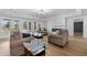 Spacious living room with a fireplace, hardwood floors and lots of natural light from the windows and door at 450 Birkdale Dr, Fayetteville, GA 30215