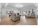 Bright, open-concept living room featuring hardwood floors, modern lighting, and seamless flow to other living spaces at 450 Birkdale Dr, Fayetteville, GA 30215