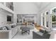 Open-concept living room with hardwood floors, large windows, and seamless flow to the kitchen at 450 Birkdale Dr, Fayetteville, GA 30215