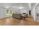 Open-concept living room featuring a fireplace, large windows, and access to the backyard at 450 Birkdale Dr, Fayetteville, GA 30215