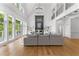 Bright living room boasts soaring ceilings, fireplace, hardwood floors, and large windows for natural light at 450 Birkdale Dr, Fayetteville, GA 30215