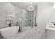 Luxurious bathroom with a soaking tub, glass shower, and elegant chandelier at 450 Birkdale Dr, Fayetteville, GA 30215