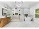 This main bathroom has a luxury shower, free standing tub, marble floors, and a modern chandelier at 450 Birkdale Dr, Fayetteville, GA 30215