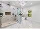 This main bathroom has a luxury shower, free standing tub, marble floors, and a modern chandelier at 450 Birkdale Dr, Fayetteville, GA 30215