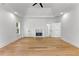 This main bedroom has hardwood floors, a fireplace, a tray ceiling, and recessed lighting at 450 Birkdale Dr, Fayetteville, GA 30215