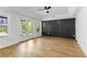 Spacious main bedroom featuring hardwood floors, a dark accent wall, and a sliding glass door to a balcony at 450 Birkdale Dr, Fayetteville, GA 30215