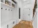 Mudroom featuring built-in bench with storage, hooks, and access to staircase at 450 Birkdale Dr, Fayetteville, GA 30215