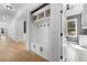 Organized mudroom with built-in bench, storage cabinets, hooks, and access to the garage and laundry room at 450 Birkdale Dr, Fayetteville, GA 30215
