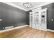Stylish office with custom built-in shelves, hardwood floors, and sophisticated gray walls at 450 Birkdale Dr, Fayetteville, GA 30215