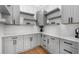 Well-organized pantry with gray cabinets, floating shelves, white countertops, and hardwood floors at 450 Birkdale Dr, Fayetteville, GA 30215