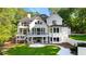 Expansive backyard with multi-story deck and patio of a white modern home with dark window trim at 450 Birkdale Dr, Fayetteville, GA 30215