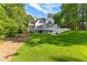 Expansive backyard of a white modern home with dark window trim and a multi-story deck at 450 Birkdale Dr, Fayetteville, GA 30215