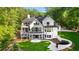 Expansive backyard with two-story deck and patio of a white modern home with dark window trim at 450 Birkdale Dr, Fayetteville, GA 30215