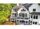 Expansive backyard with two-story deck and patio of a white modern home with dark window trim at 450 Birkdale Dr, Fayetteville, GA 30215