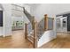 Elegant staircase with wood and iron railing, leading to a bright, open space at 450 Birkdale Dr, Fayetteville, GA 30215
