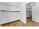 Bright walk-in closet features custom built-in shelving and a convenient hanging rod for optimal storage and organization at 450 Birkdale Dr, Fayetteville, GA 30215