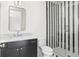 Modern bathroom featuring black and white striped tile shower and vanity with marble countertop at 48 25Th St, Atlanta, GA 30309