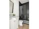 Elegant bathroom with black herringbone tile shower and white vanity at 48 25Th St, Atlanta, GA 30309