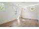 Bright bedroom featuring hardwood flooring, three windows for natural light, and neutral walls at 48 25Th St, Atlanta, GA 30309