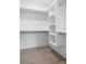Bright walk-in closet featuring custom shelving and hardwood floors at 48 25Th St, Atlanta, GA 30309