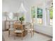 Bright dining room features a beaded chandelier, a round table with four chairs, and large windows for natural light at 48 25Th St, Atlanta, GA 30309
