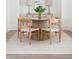 Bright dining room features a round table with four chairs, and a light striped area rug on hardwood flooring at 48 25Th St, Atlanta, GA 30309