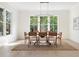 Light-filled dining room with large windows, a modern chandelier, and seating for eight at 48 25Th St, Atlanta, GA 30309