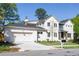 Lovely two-story home with a two-car garage and a white painted brick exterior at 48 25Th St, Atlanta, GA 30309