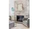 Stone fireplace with hearth and mantle, flanked by gray armchairs, for a cozy gathering space at 48 25Th St, Atlanta, GA 30309