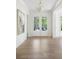 Elegant foyer with light hardwood floors, white trim, and a modern light fixture at 48 25Th St, Atlanta, GA 30309