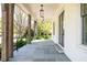 Inviting front porch showcasing stone flooring, timber columns, and stylish pendant lights at 48 25Th St, Atlanta, GA 30309