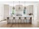 Modern kitchen with a large island, marble countertops, pendant lighting, and bar stool seating at 48 25Th St, Atlanta, GA 30309