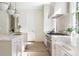 Bright kitchen with marble countertops, custom cabinets, stainless appliances, and pendant lighting at 48 25Th St, Atlanta, GA 30309
