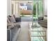 Bright living room featuring gray sofas, a glass coffee table, and a view to the outdoor patio at 48 25Th St, Atlanta, GA 30309